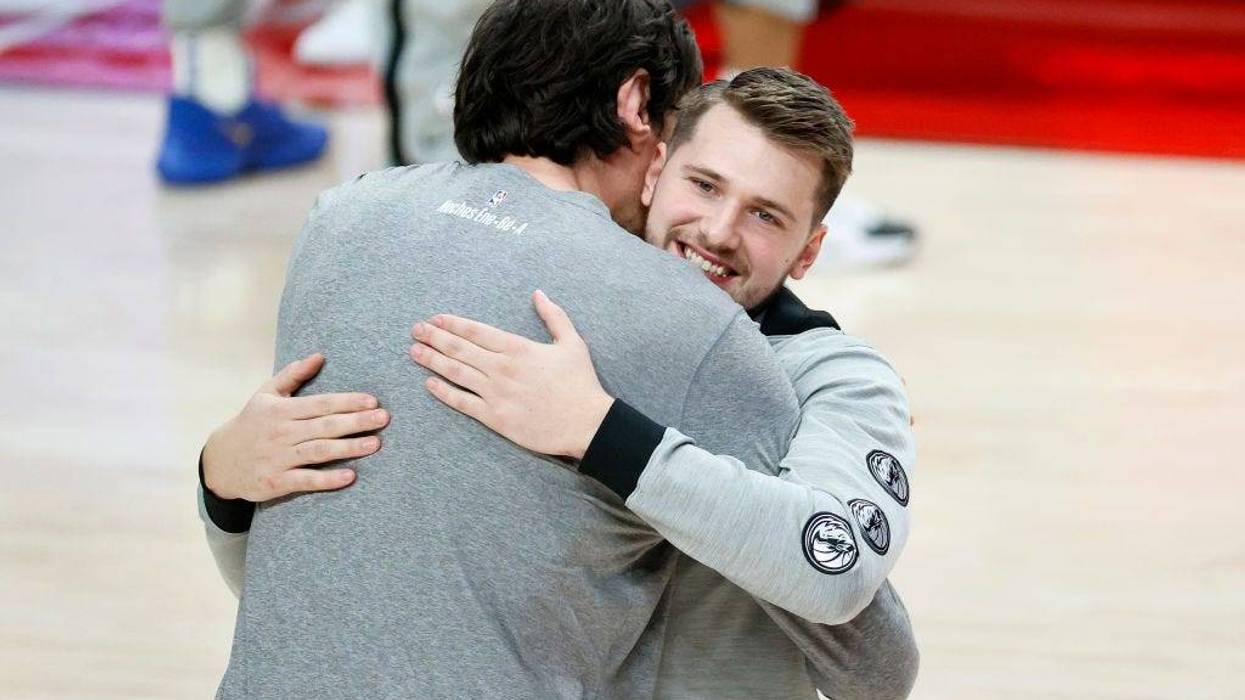Boban Marjanovic #51 and Luka Doncic #77 of the Dallas Mavericks embrace before the game against the Portland Trail Blazers at Moda Center on March 19, 2021.