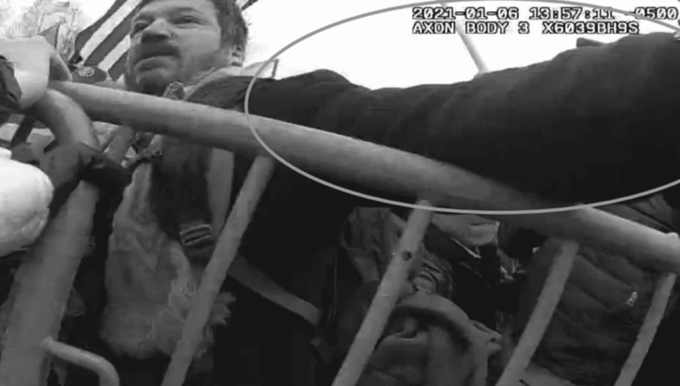Body cam footage shows Neumann punching towards one of the officers at the Capitol.
