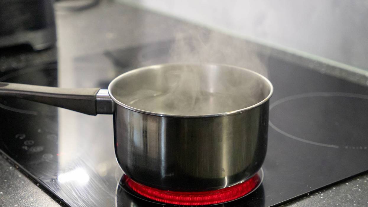 Boiling water on the kitchen stove. Cooking food in the kitchen