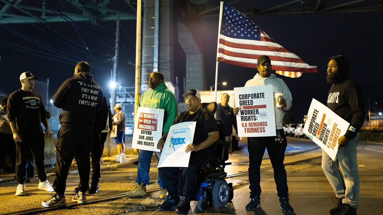 Boise Butler, president of Local 1291, with an American flag on his wheelchair, pickets with his fellow longshoremen outside the Packer Avenue Marine Terminal Port in Philadelphia on Oct. 1, 2024.