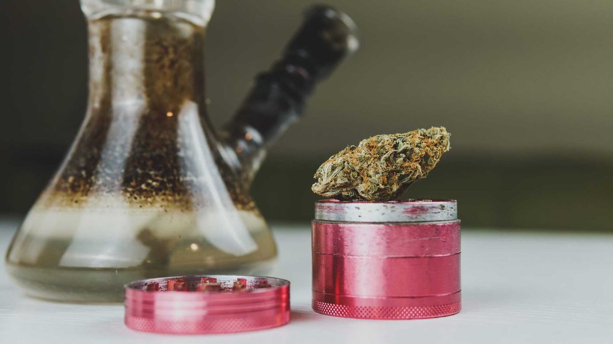 Bong and weed grinder stock photo.
