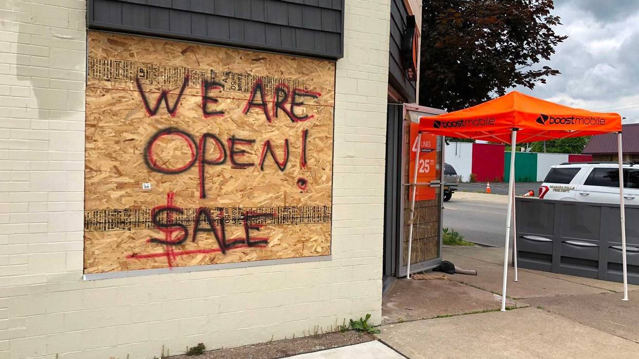 Boost Mobile on Pine Avenue in Niagara Falls is open despite plywood on its windows. June 11, 2020 (WBEN Photo/Mike Baggerman)
