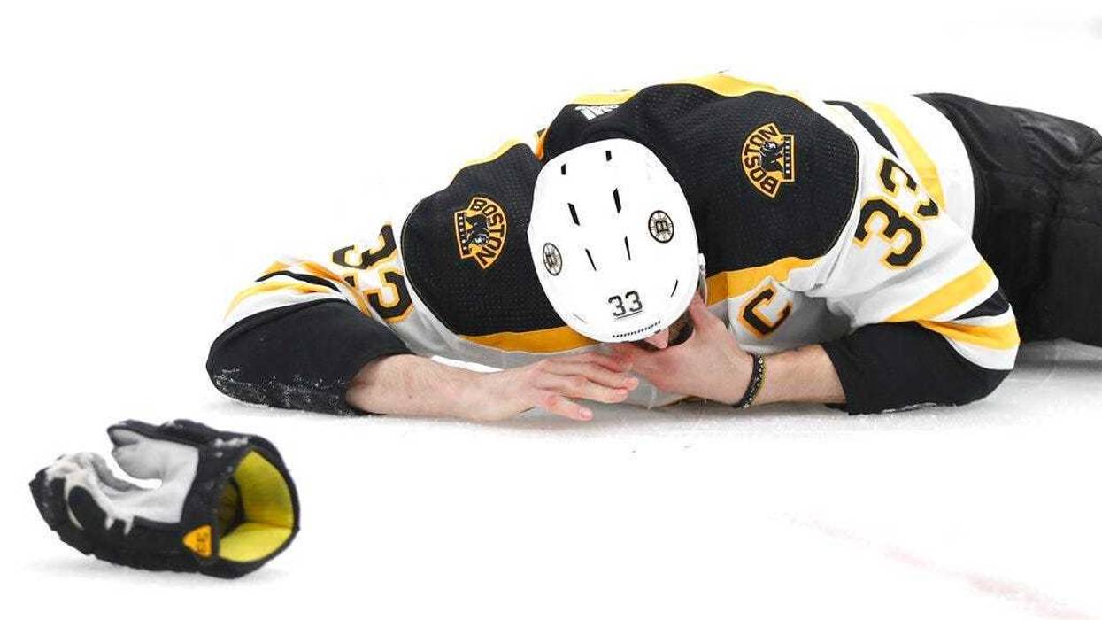 Boston Bruins defenseman Zdeno Chara, of Slovakia, lies on the ice after getting hit in the face with the puck during the second period of Game 4 of the NHL hockey Stanley Cup Final against the St. Louis Blues Monday, June 3, 2019, in St. Louis. (