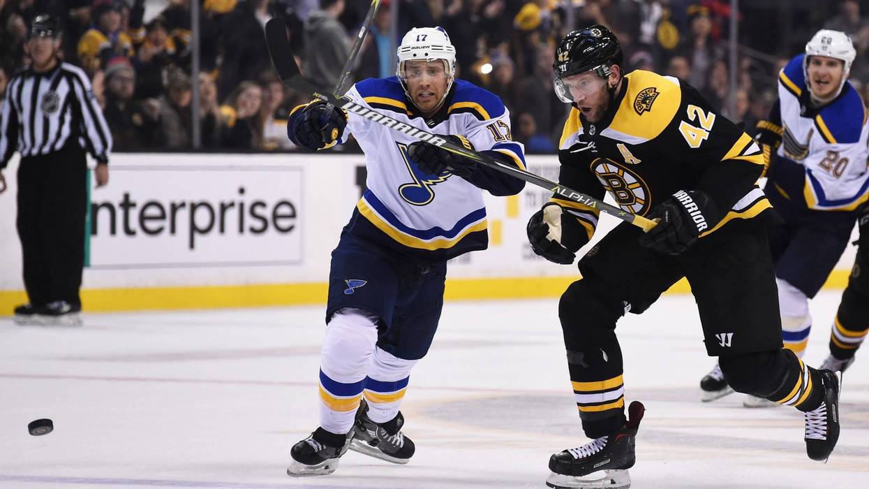 Boston Bruins right wing David Backes (42) skates after a loose puck ahead of St. Louis Blues left wing Jaden Schwartz