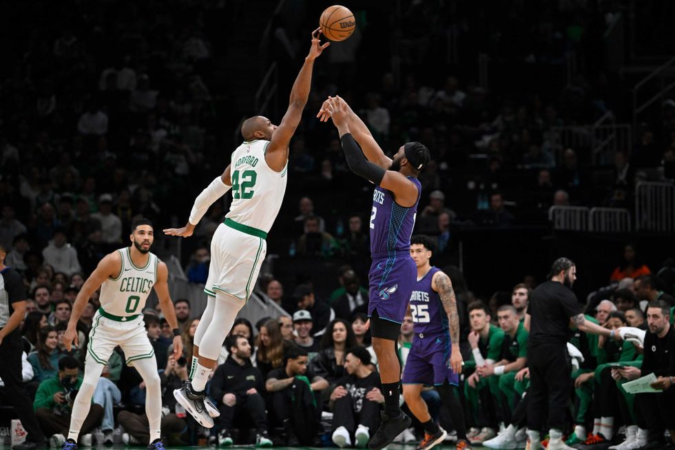 Boston Celtics center Al Horford (42) blocks a shot by Charlotte Hornets forward Josh Okogie (12) during the first half at TD Garden.