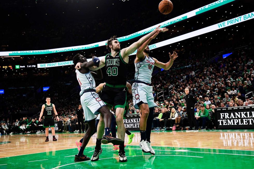 Boston Celtics center Luke Kornet (40) and Washington Wizards forward Anthony Gill (16) battle for a loose ball during the second half at TD Garden.