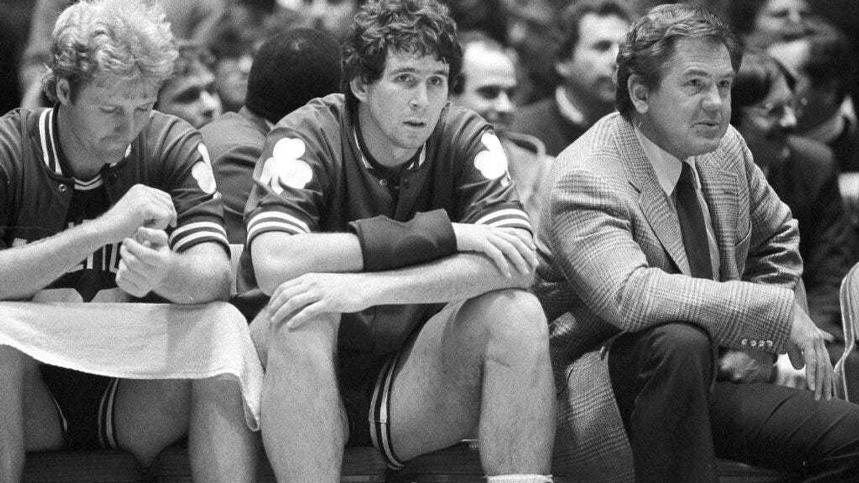 Boston Celtics coach Bill Fitch and players Rick Robey, center, and Larry Bird watch from the bench as their team loses to the Philadelphia 76ers 122-105 in an NBA basketball game Philadelphia.