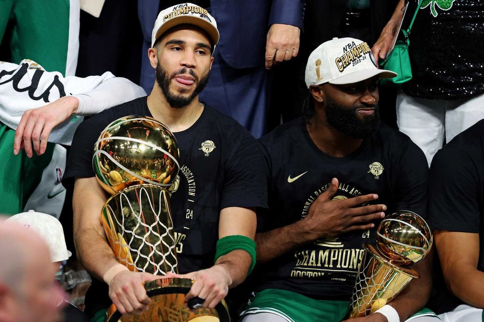 Boston Celtics forward Jayson Tatum (0) and guard Jaylen Brown (7) celebrates with the Larry O