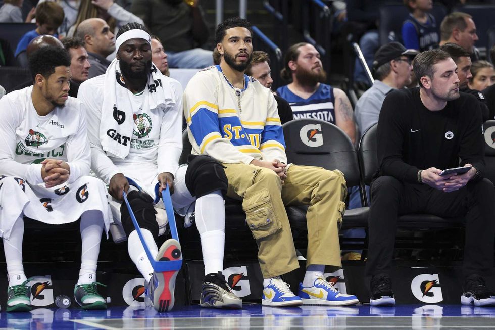 Boston Celtics forward Jayson Tatum (0) (center) looks on during a game against the Orlando Magic in the first quarter at Kia Center.