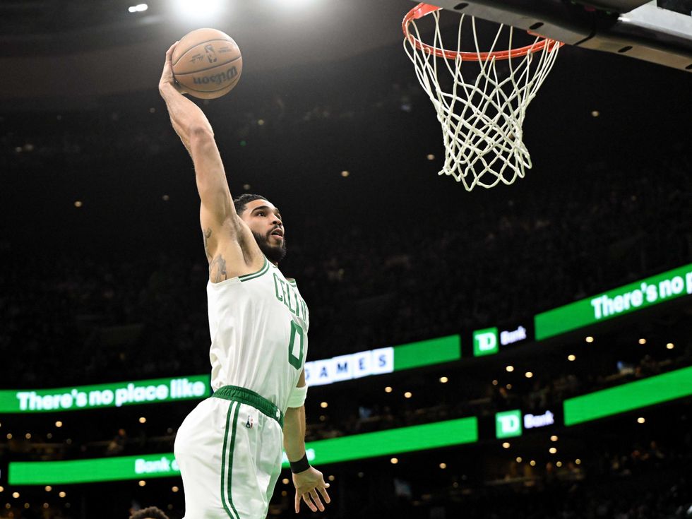 Boston Celtics forward Jayson Tatum (0) dunks and scores against the San Antonio Spurs during the first quarter at the TD Garden.