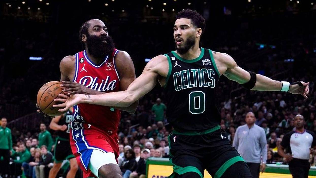Boston Celtics forward Jayson Tatum tries to steal against Philadelphia 76ers guard James Harden during the first half of Game 1 in the NBA Eastern Conference semifinals playoff series in Boston.