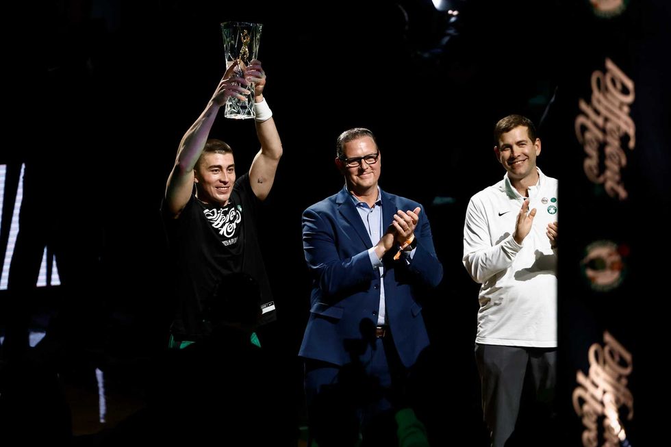 Boston Celtics guard Payton Pritchard (11) holds up the 2025 NBA Sixth Man Award as Celtics president of basketball operations Brad Stevens, right, applauds before game two of the first round of the 2024 NBA Playoffs between the Boston Celtics and the Orlando Magic at TD Garden. Mandatory Credit: Winslow Townson-Imagn Images