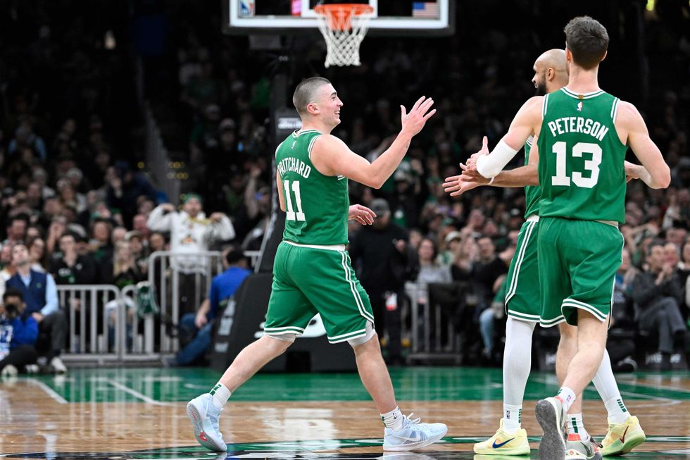 Boston Celtics guard Payton Pritchard (11) reacts to his three point basket against the Detroit Pistons during the second half at TD Garden.