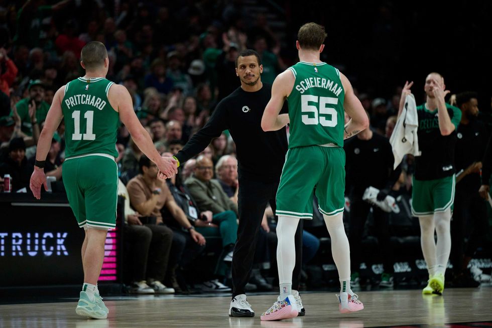 Boston Celtics head coach Joe Mazzulla greets players during a time out during the second half against the Portland Trail Blazers at Moda Center.