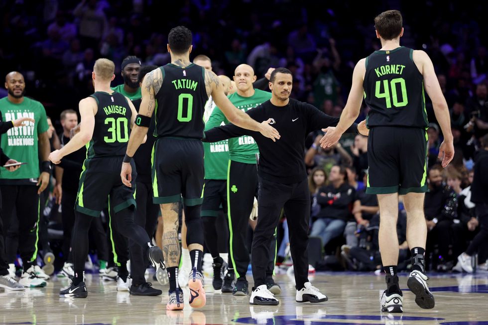Boston Celtics head coach Joe Mazzulla high fives Jayson Tatum #0 and Luke Kornet #40 during the second half against the Philadelphia 76ers at the Wells Fargo Center on February 02, 2025 in Philadelphia, Pennsylvania