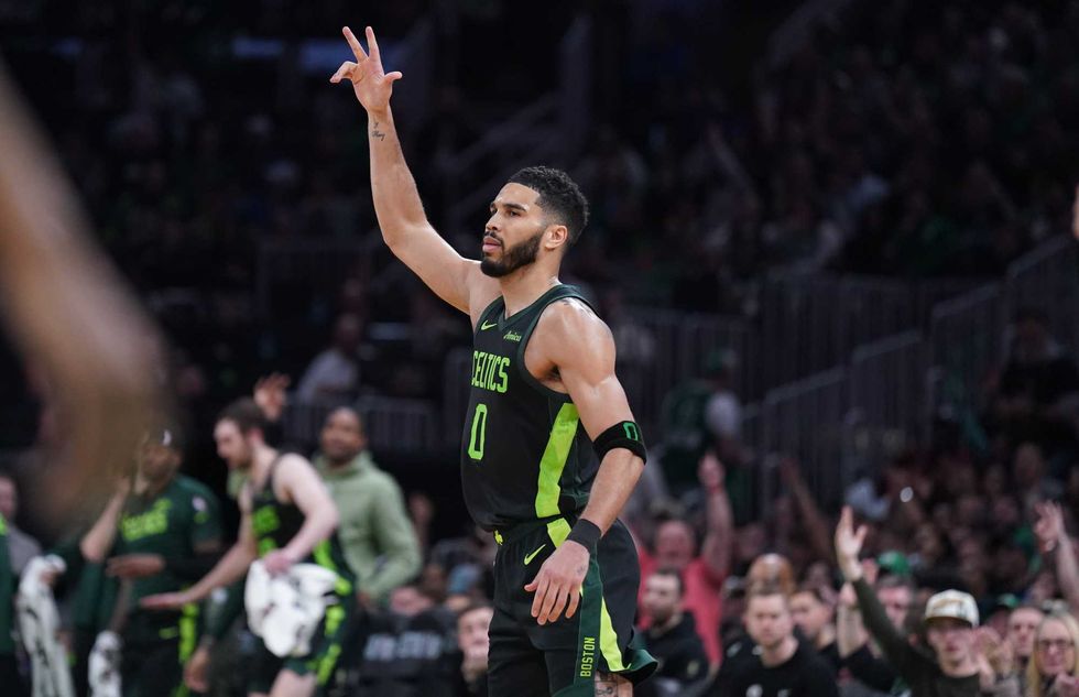 Boston, Massachusetts, USA; Boston Celtics forward Jayson Tatum (0) reacts after his three point basket against the Philadelphia 76ers in the second half at TD Garden.