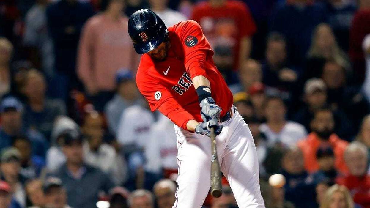 Boston Red Sox's J.D. Martinez hits an RBI single during the eighth inning