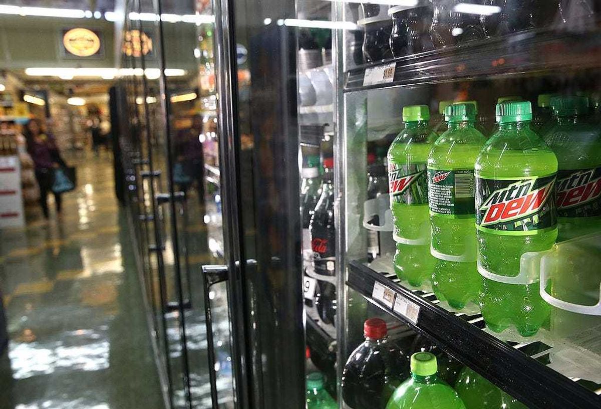 Bottles of Mountain Dew are displayed in a cooler.