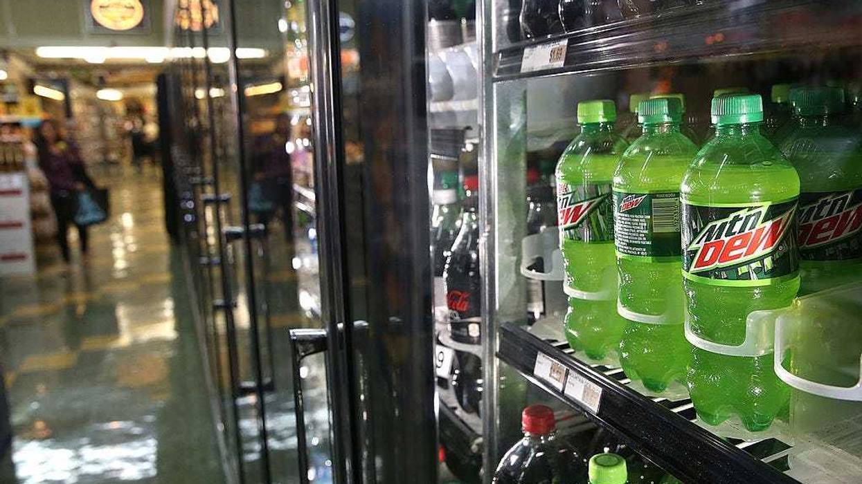 Bottles of Mountain Dew are displayed in a cooler.