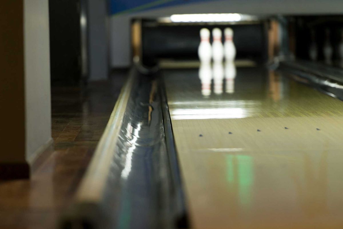 Bowling Ball Focused And At The End, The Pins Waiting For The Shot