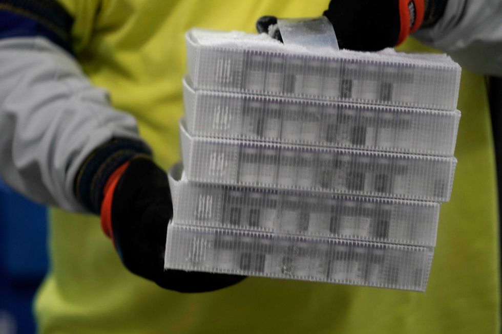 Boxes containing the Pfizer-BioNTech COVID-19 vaccine are prepared to be shipped at the Pfizer Global Supply Kalamazoo manufacturing plant on December 13, 2020 in Portage, Michigan.