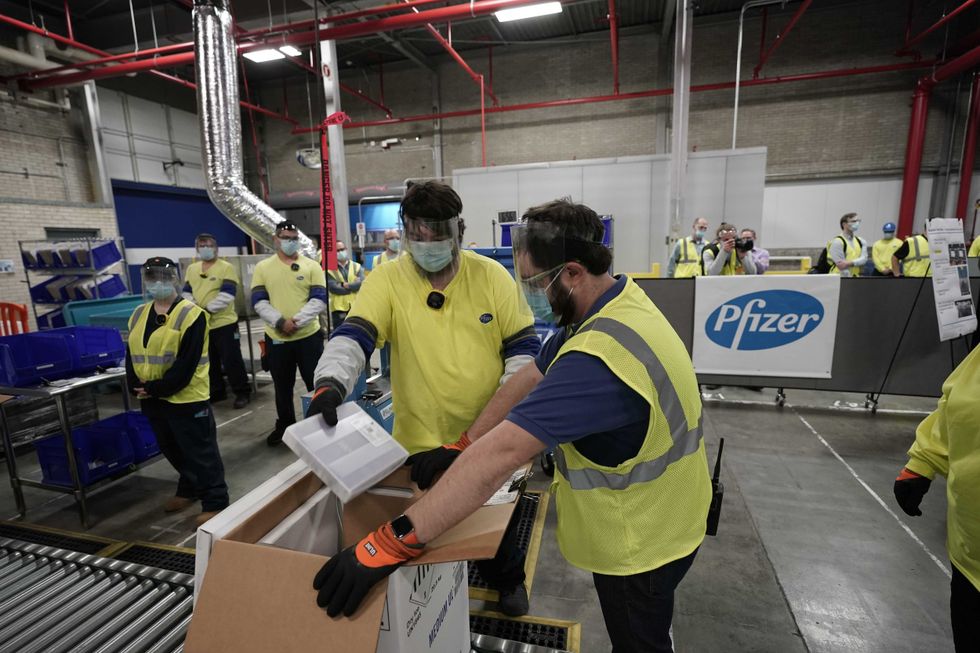 Boxes containing the Pfizer-BioNTech COVID-19 vaccine are prepared to be shipped at the Pfizer Global Supply Kalamazoo manufacturing plant on December 13, 2020 in Portage, Michigan.