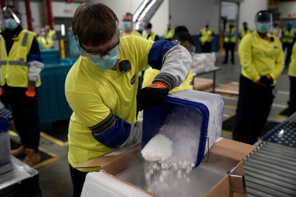 Boxes containing the Pfizer-BioNTech COVID-19 vaccine are prepared to be shipped at the Pfizer Global Supply Kalamazoo manufacturing plant on December 13, 2020 in Portage, Michigan. (