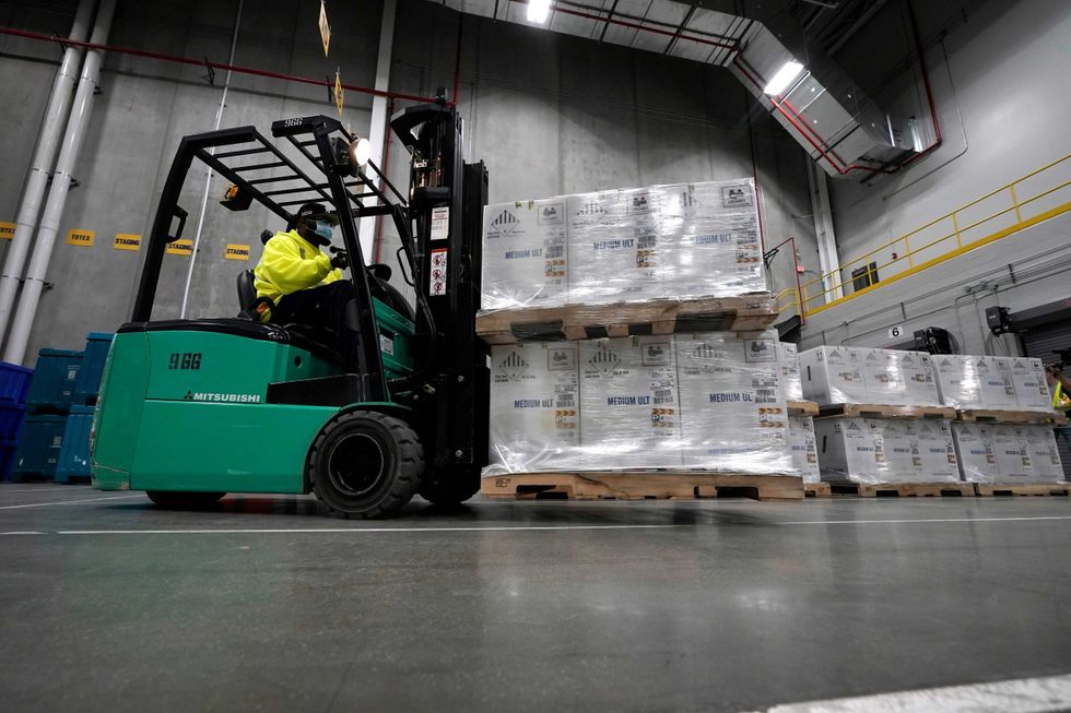 Boxes containing the Pfizer-BioNTech COVID-19 vaccine are prepared to be shipped at the Pfizer Global Supply Kalamazoo manufacturing plant on December 13, 2020 in Portage, Michigan.
