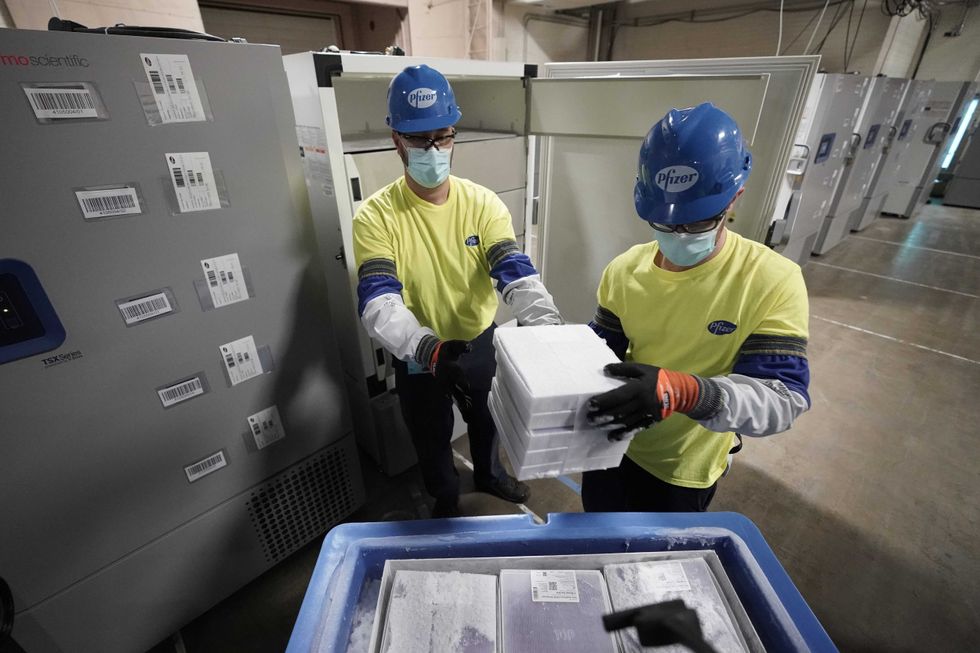 Boxes containing the Pfizer-BioNTech COVID-19 vaccine are prepared to be shipped at the Pfizer Global Supply Kalamazoo manufacturing plant on December 13, 2020 in Portage, Michigan.