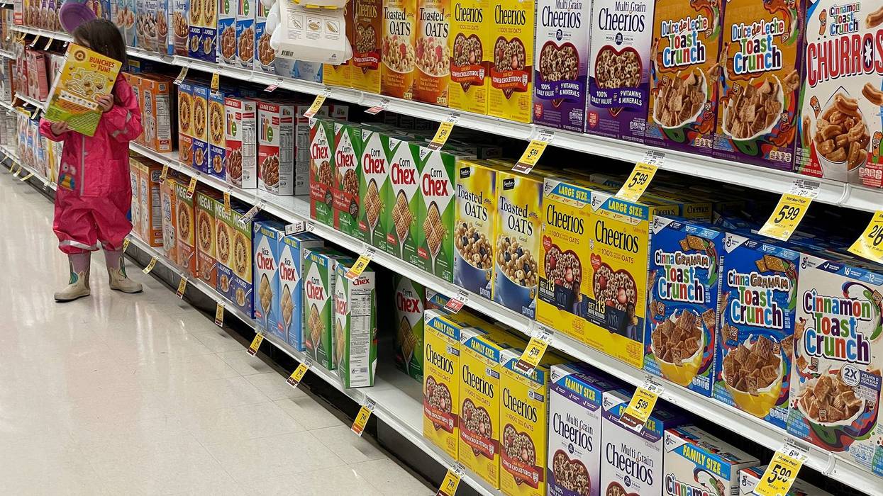 Boxes of General Mills cereal are displayed on a grocery store shelf