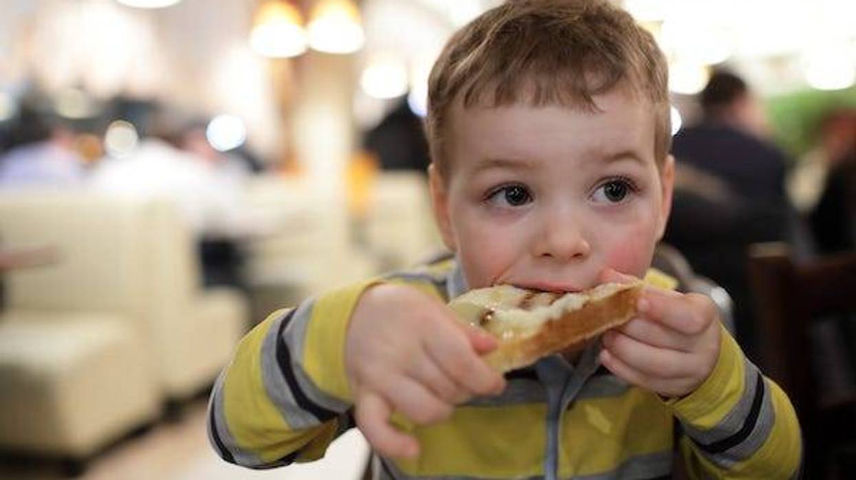 Boy eating bruschetta at a restaurant