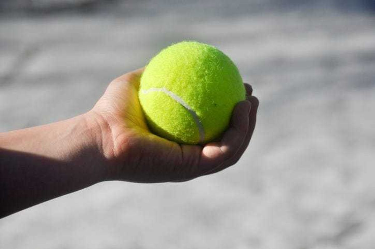 boy holding a tennis ball