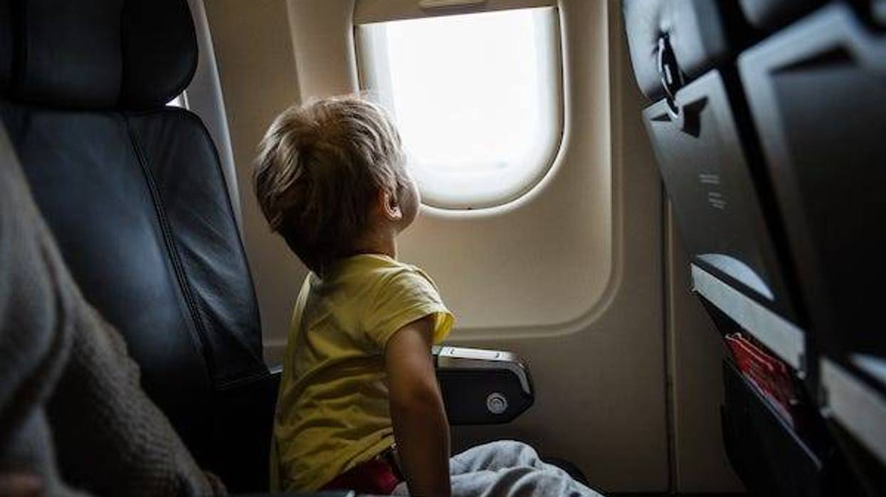 Boy looking out of window in airplane