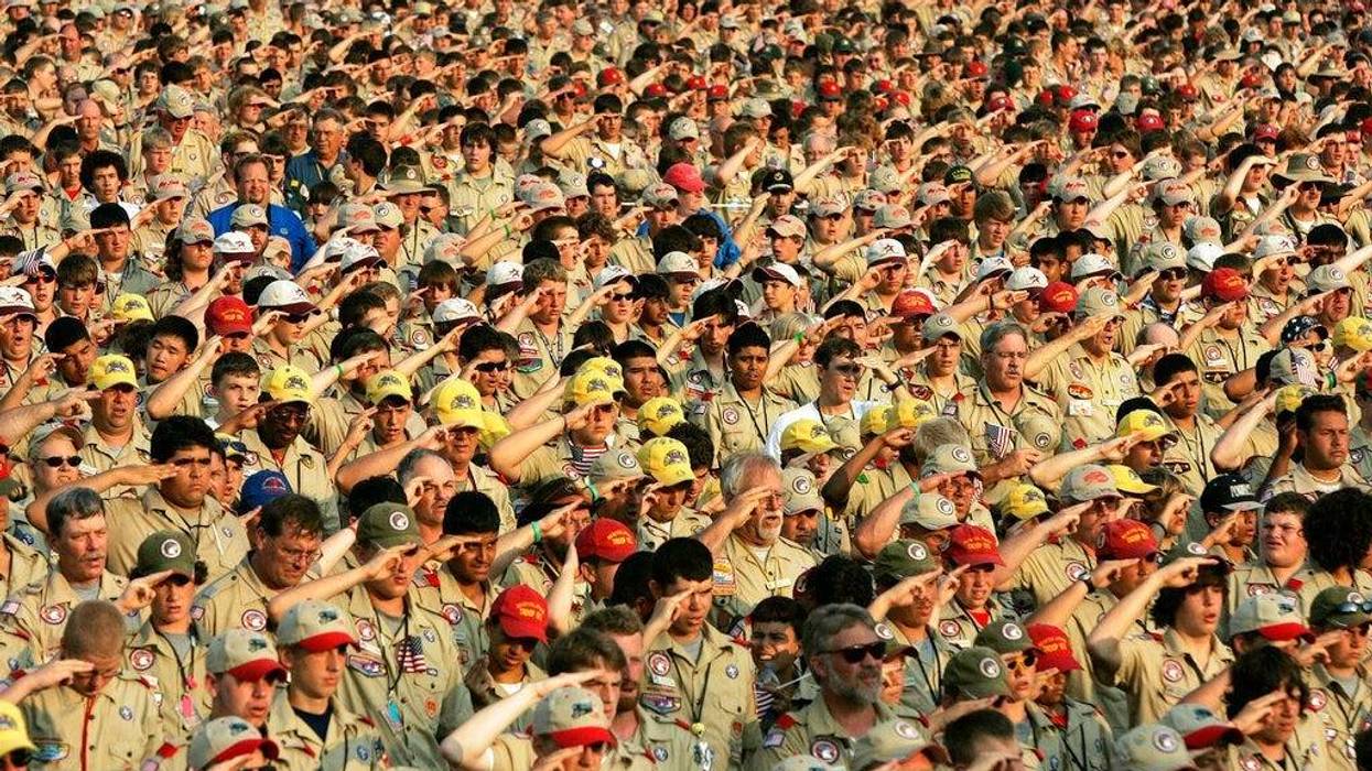 Boy Scouts salute as they recite the Pledge of Allegiance during the Boy Scout Jamboree