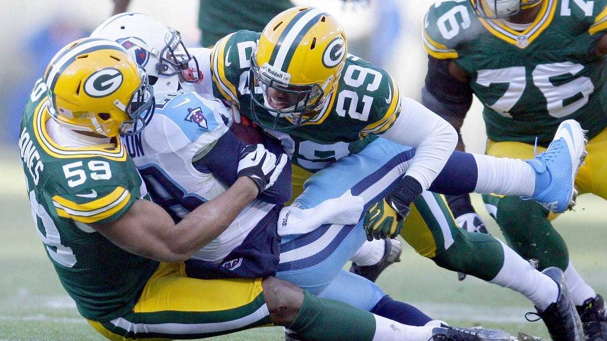 Brad Jones (59) and Casey Hayward (29) tackle titans Chris Johnson in the 3rd quarter of The Green Bay Packers face the Tennessee Titans at Lambeau Field on December 23, 2012.