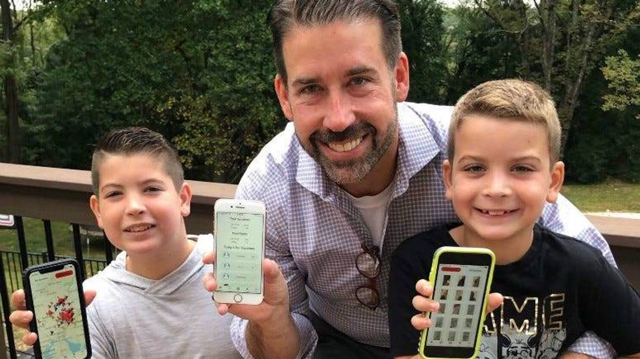 Brad Line of Villanova and his sons, Grayson and Nolan, showing off their app, Squishr, for tracking spotted lanternflies.