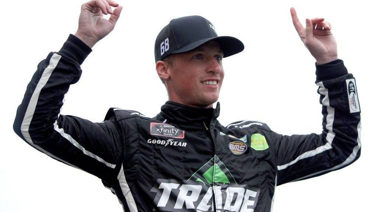 Brandon Brown, driver of the #68 TradeTheChain.com Chevrolet, waves to fans during pre-race ceremonies prior to the NASCAR Xfinity Series Kansas Lottery 300 at Kansas Speedway on October 23, 2021 in Kansas City, Kansas. (Photo by Sean Gardner/Getty Images)