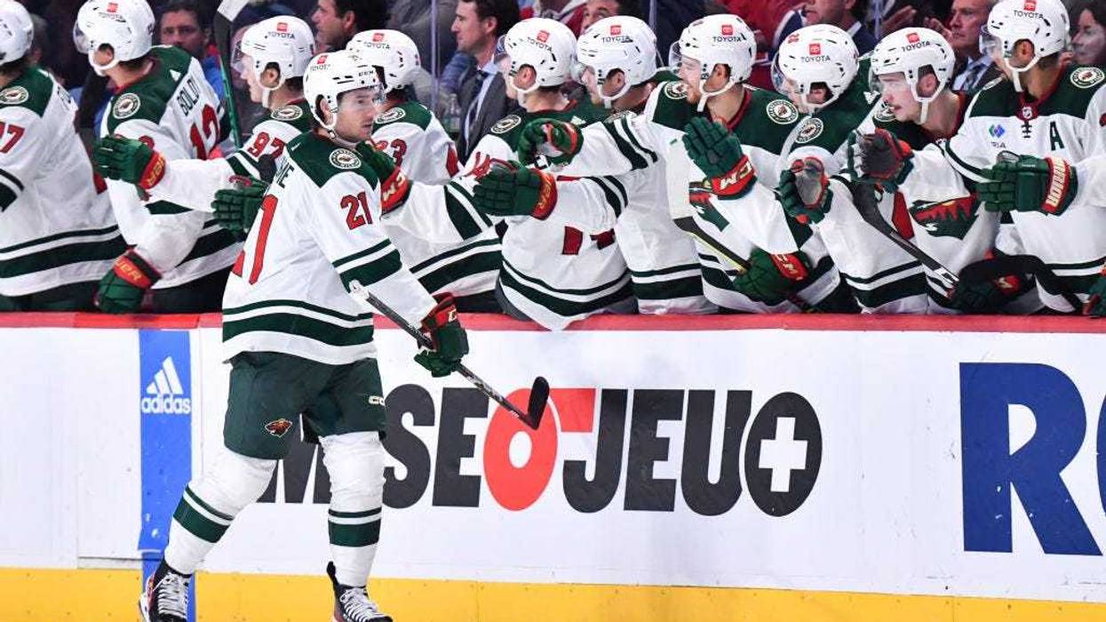 Brandon Duhaime #21 of the Minnesota Wild celebrates his goal with teammates on the bench during the second period against the Montreal Canadiens at Centre Bell on October 25, 2022 in Montreal, Quebec, Canada.