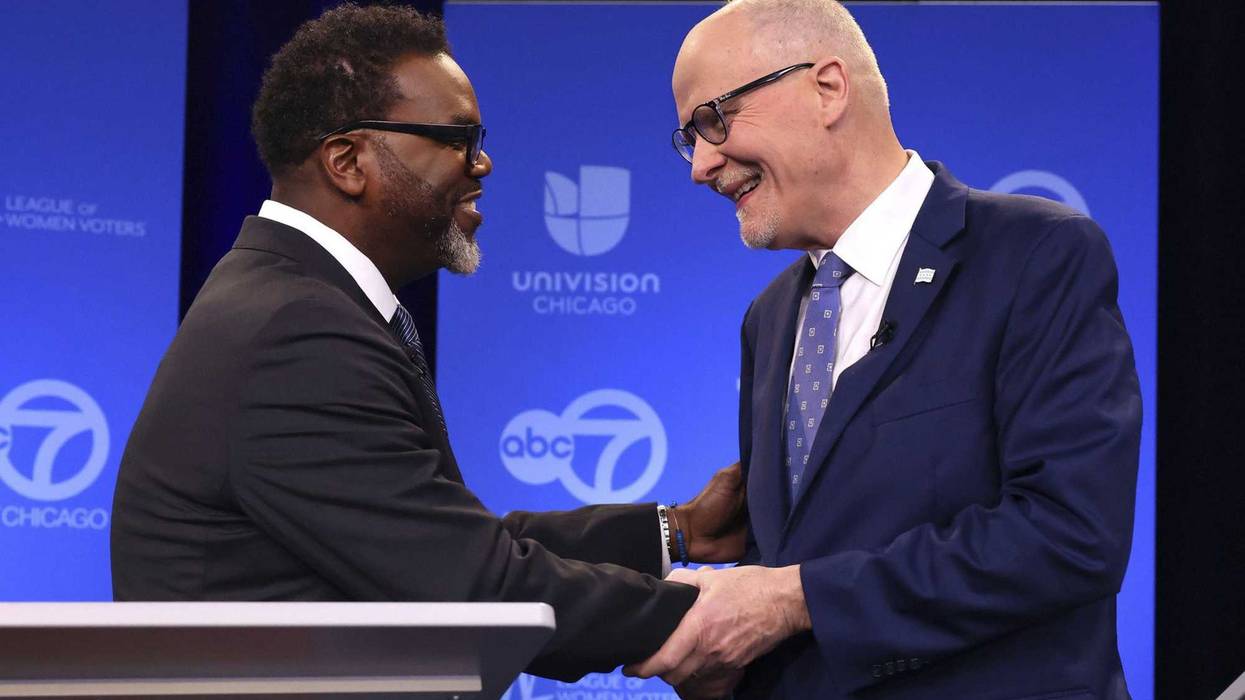 Brandon Johnson, Paul Vallas shaking hands at forum