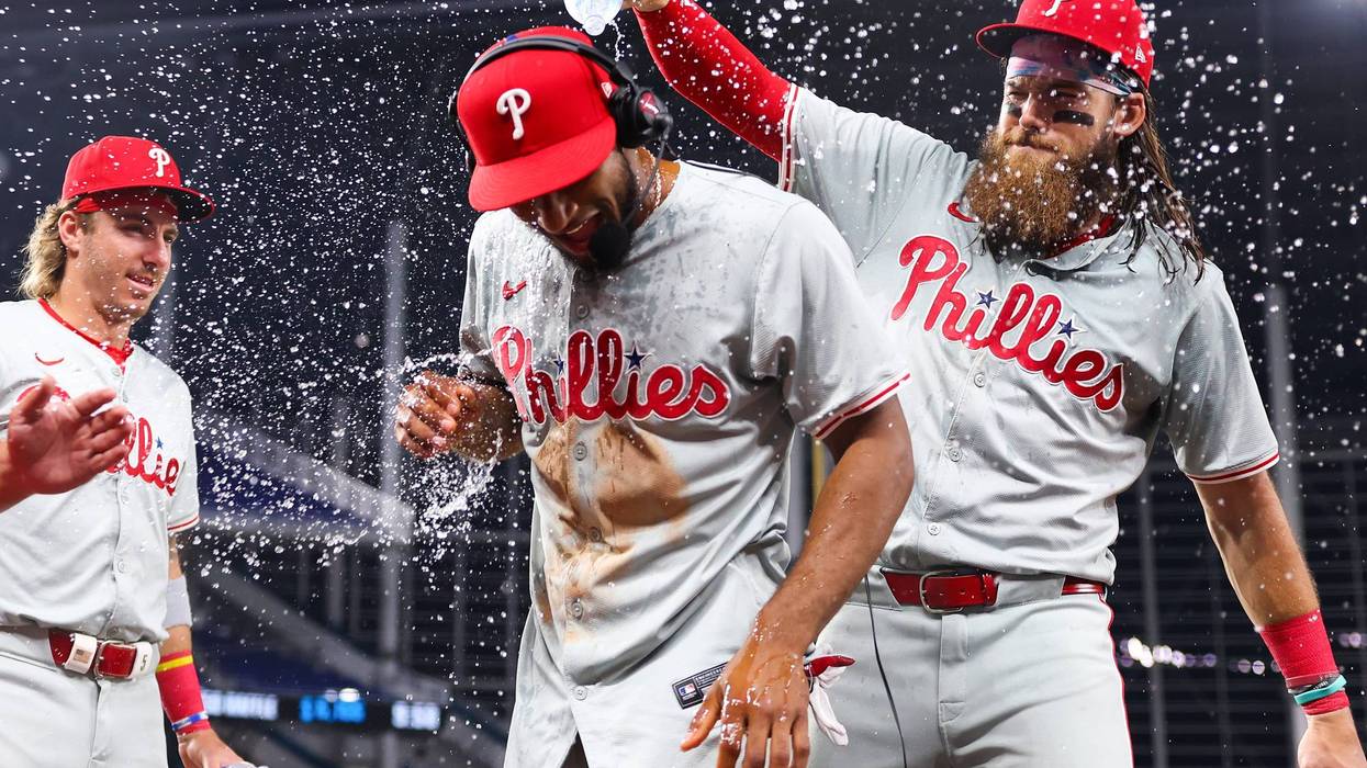 Brandon Marsh, #16 of the Philadelphia Phillies, dumps water on teammate Johan Rojas, #18, after defeating the Miami Marlins at loanDepot Park on May 10, 2024, in Miami, Florida.