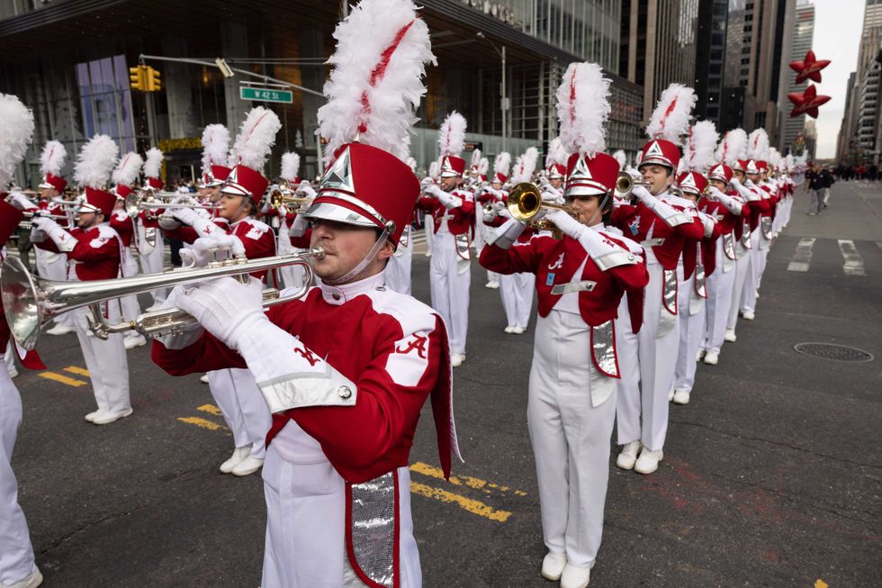 Brass band members play trumpets during the Macy