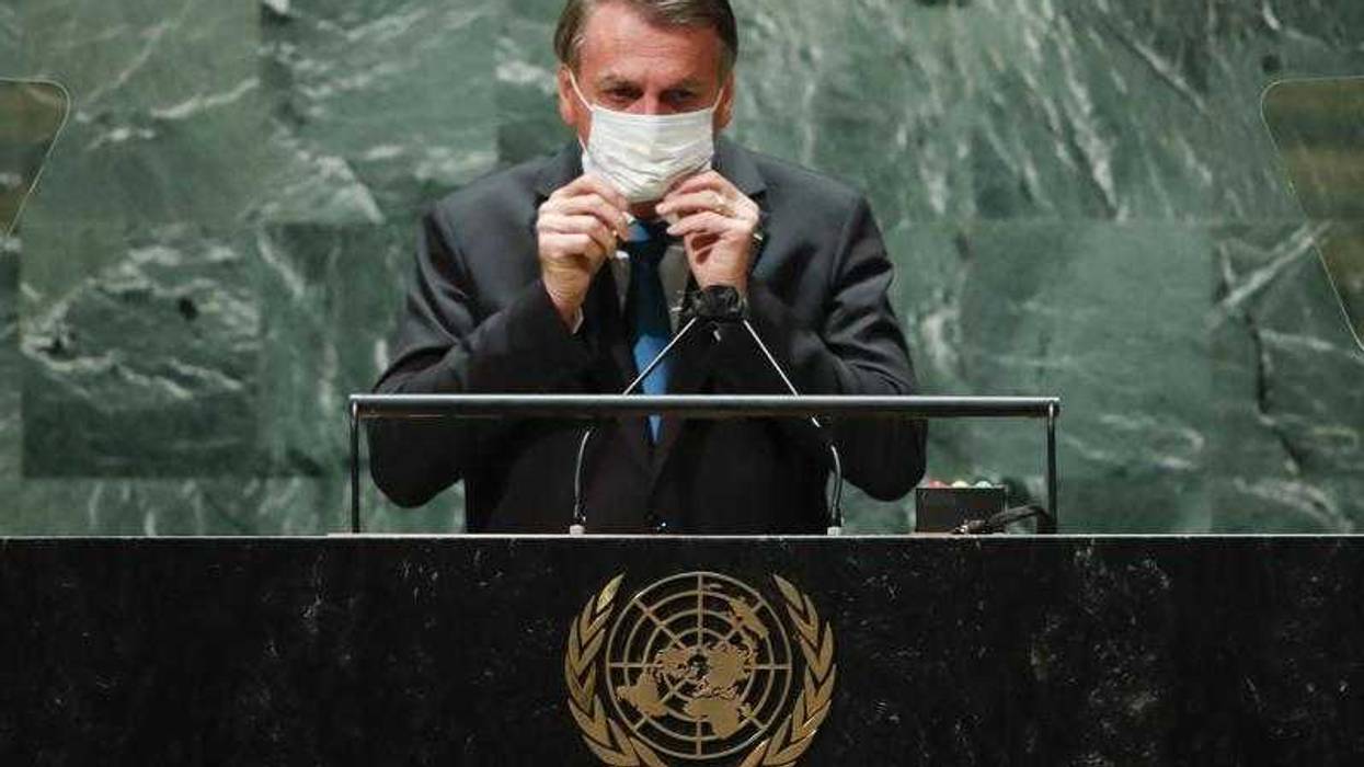 Brazil's President Jair Bolsonaro puts back on a protective face mask after speaking during the 76th Session of the United Nations General Assembly at U.N. headquarters in New York on Tuesday, Sept. 21, 2021. (Eduardo Munoz/Pool Photo via AP)