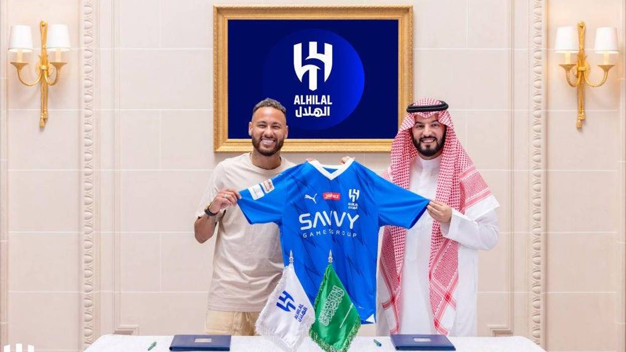 Brazilian football star Neymar (L) and Al-Hilal's president Fahad bin Nafel (R) pose for a photo with an Al Hilal jersey as Neymar joins Al-Hilal with a two-year contract in Riyadh, Saudi Arabia