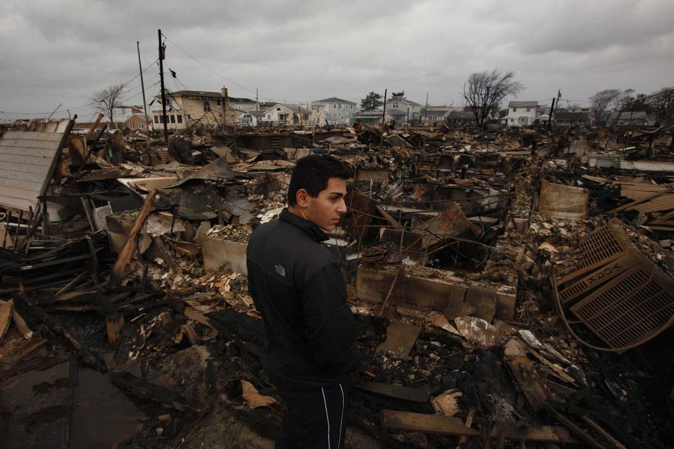Breezy Point, Queens, was devastated by Sandy. Beka Baidarashvili, 18, stands near the scene of a massive fire on Oct. 30, 2012