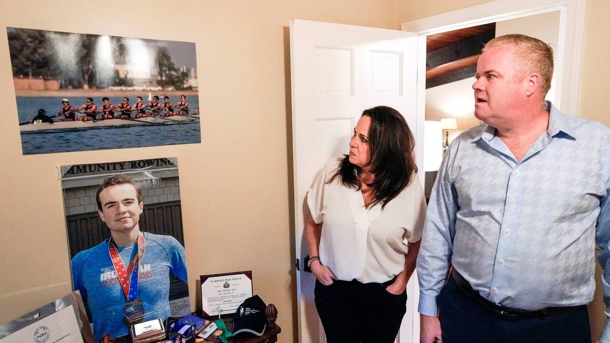 Brenda and Brian Lilly look at photos of their son Brian Lilly Jr. in their Easton, Conn. home, Thursday, Oct. 13, 2022. Brian Lilly Jr., 19, who committed suicide on Jan. 4, 2021, was a rower at University of California San Diego. The Lillys have filed a wrongful death lawsuit against the university and the rowing coach, Geoff Bond, who is no longer with the school.