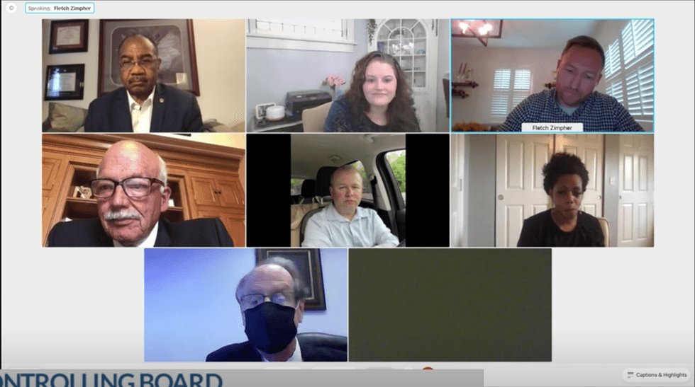 Brenner sits in his vehicle at the start of the meeting.