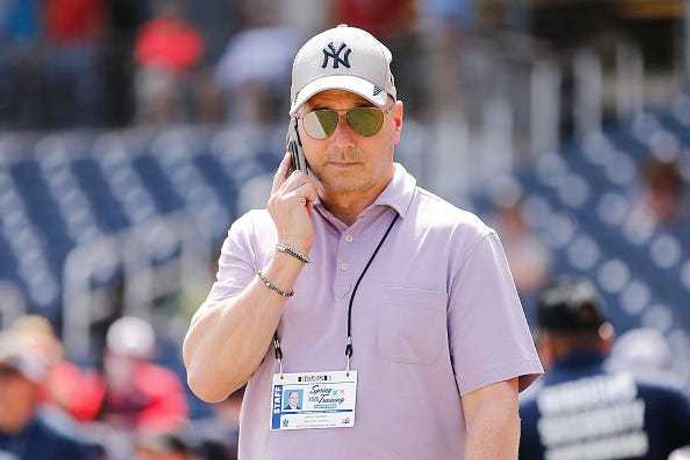 Brian Cashman takes a call during Yankees spring training.