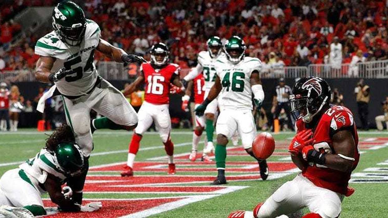 Brian Hill of the Atlanta Falcons fails to pull in this reception for a TD against Tevaughn Campbell and Avery Williamsonof the Jets on Aug. 15, 2019 in Atlanta.