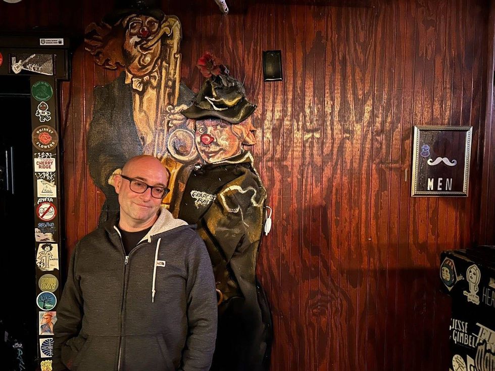 Brian "Scooter" Hassinger stands by the back wall of The Grape Room, one of his favorite spots in the venue.