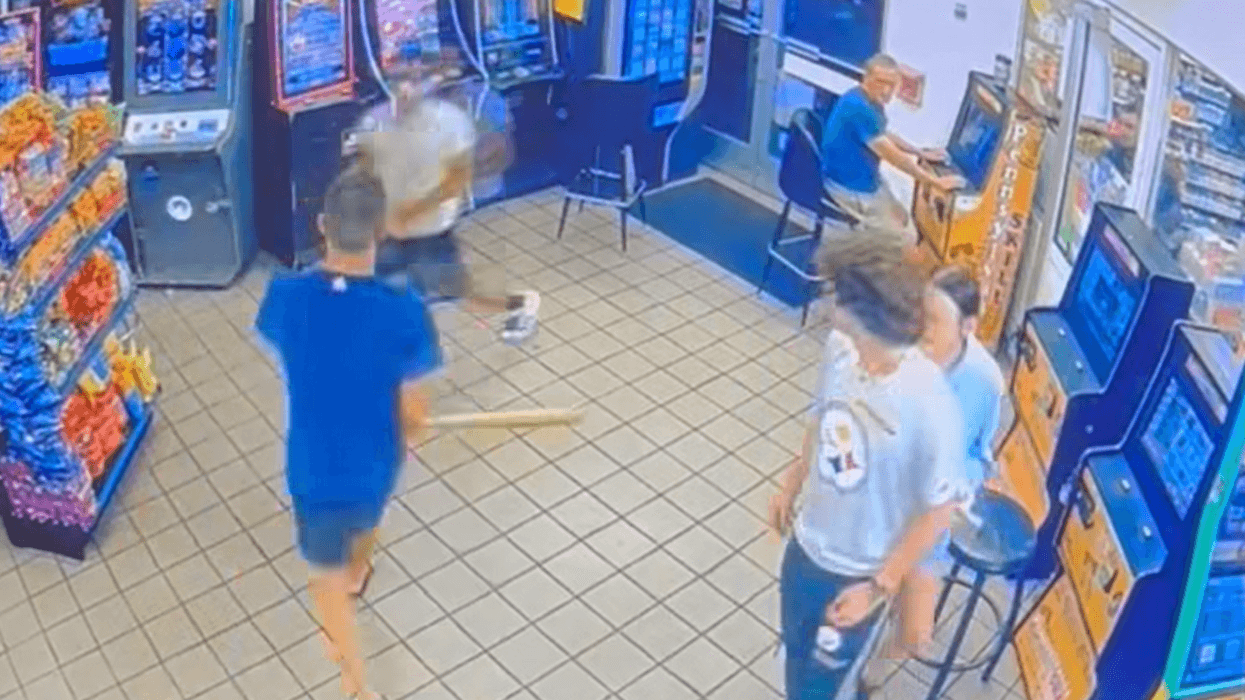 Brian Taylor chases a man around the gas station with a bat in surveillance video released by police.